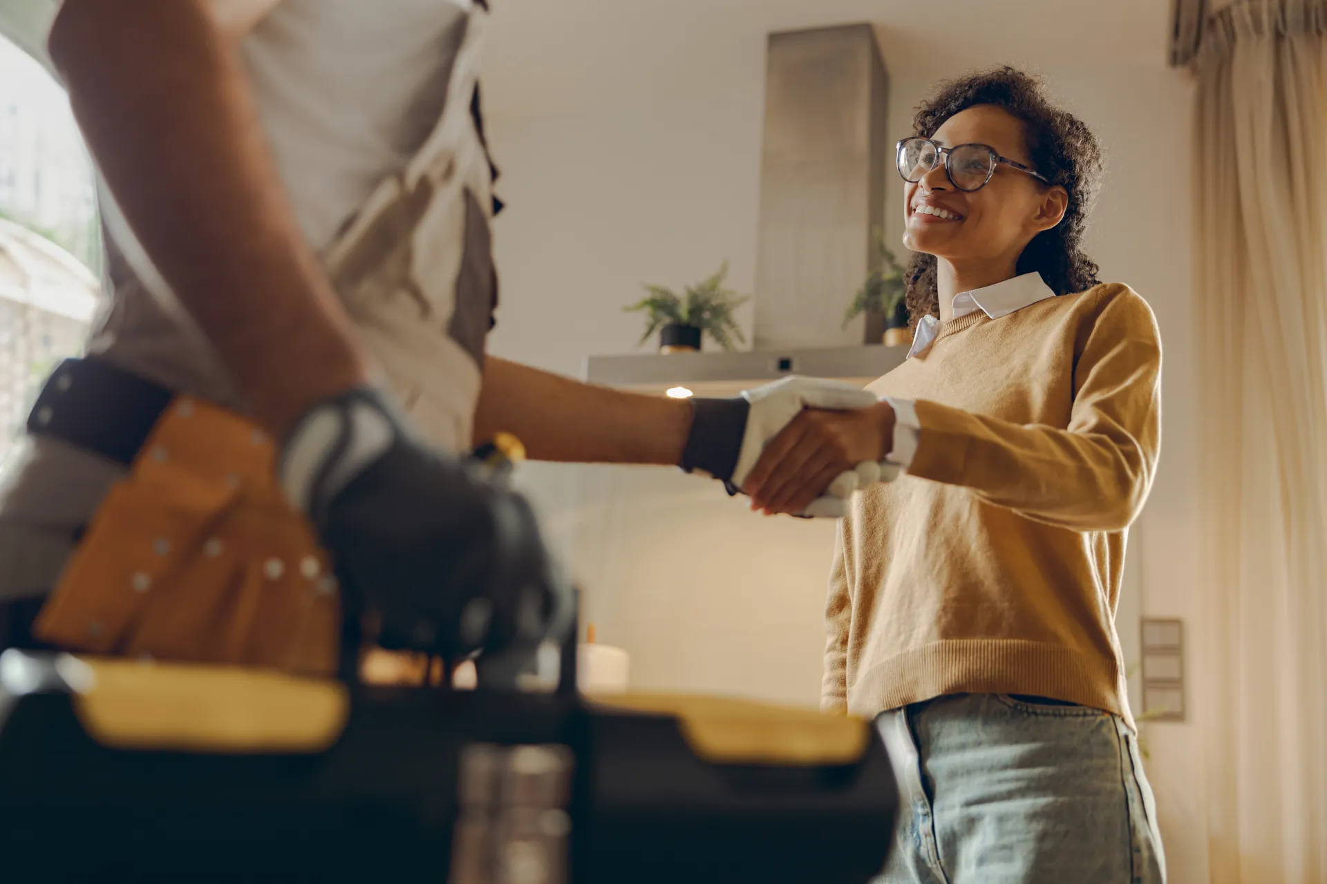 Plumbing business owner shaking hands with a customer