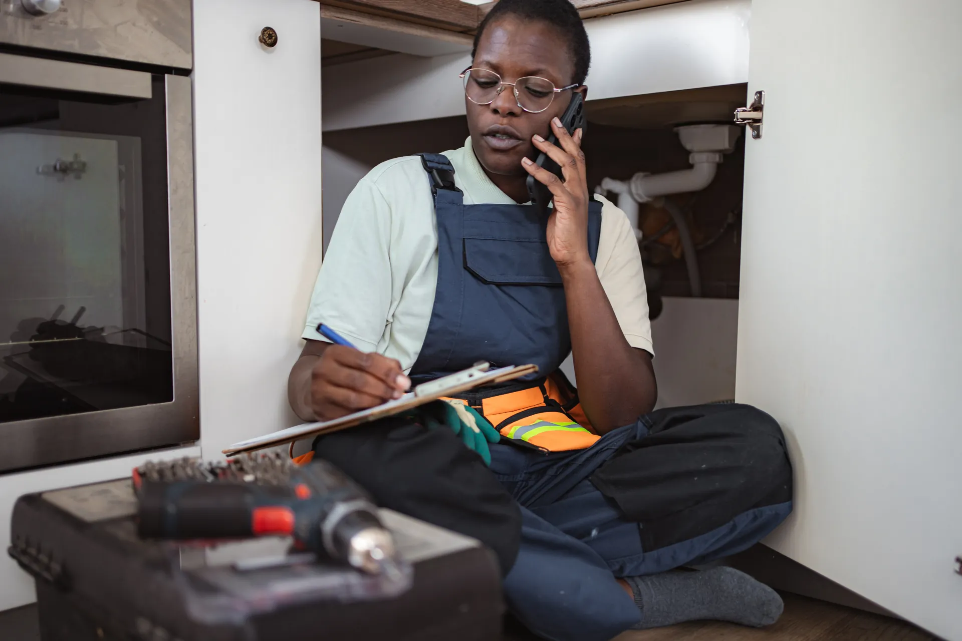 Worker taking a phone call near plumbing
